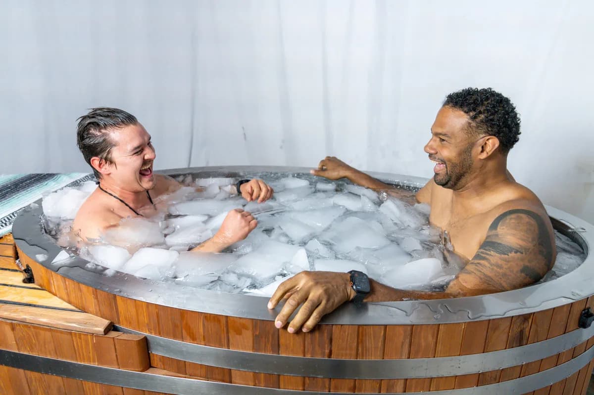 Morozko Ice Bath classic cedar lay-down cold plunge with a layer of real ice on the water